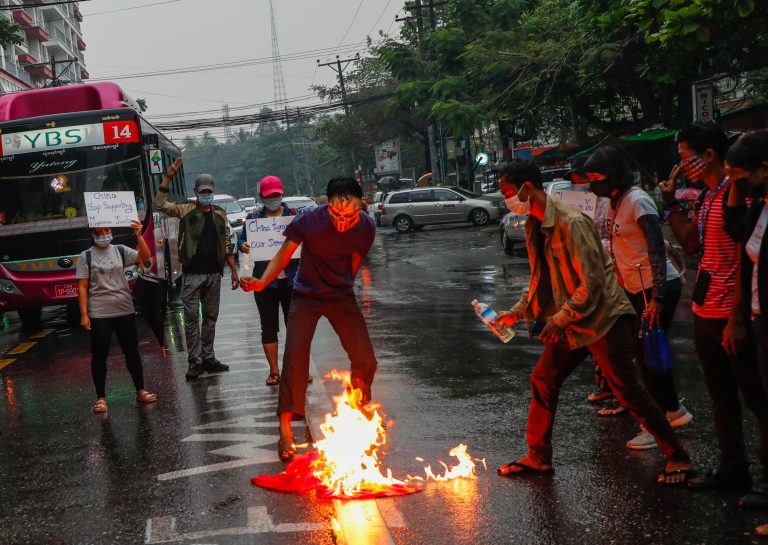 Protesters burn a Chinese flag in Yangon to show their anger at its response to the military coup. (Frontier)
