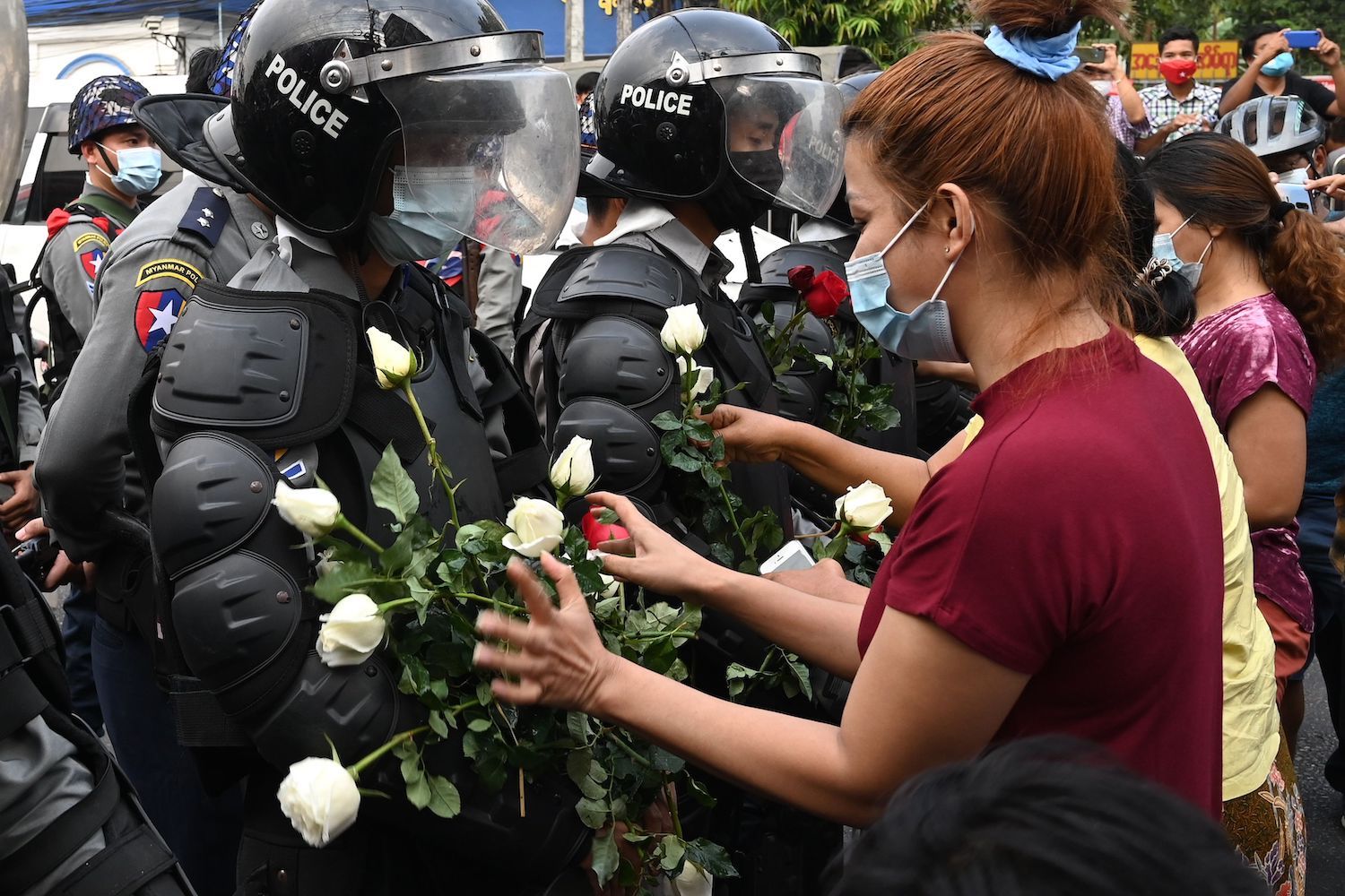 Protesters appeal to police to join them in the days following the coup in February of last year (AFP)