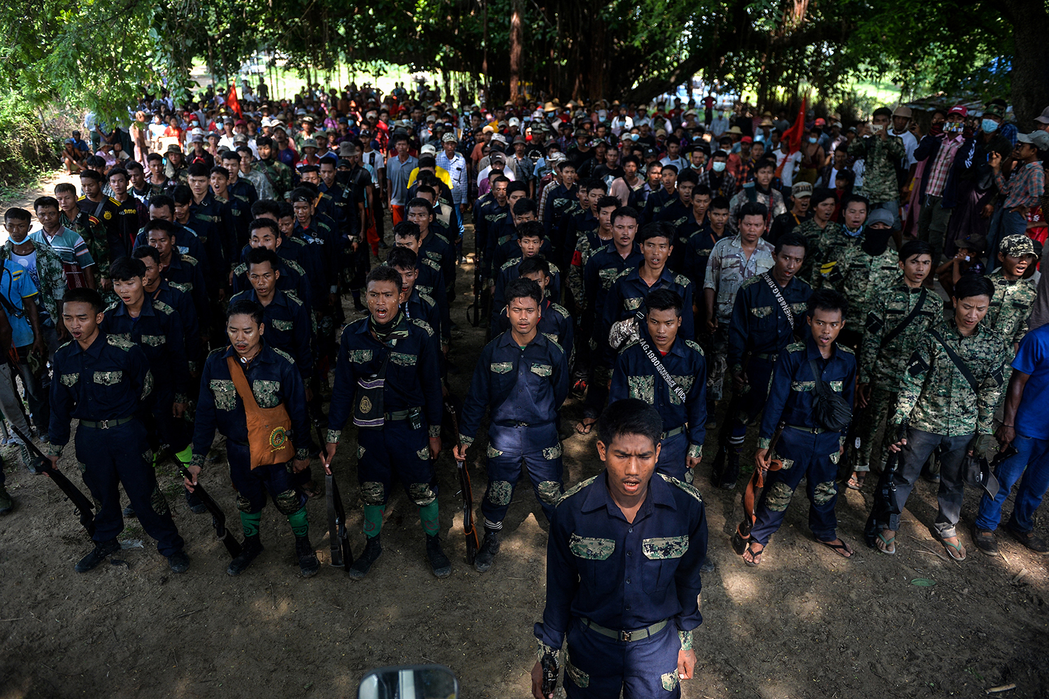 Resistance members sing a revolutionary song as they escort protesters during a demonstration against the regime in Sagaing Township on September 7, 2022. (AFP)