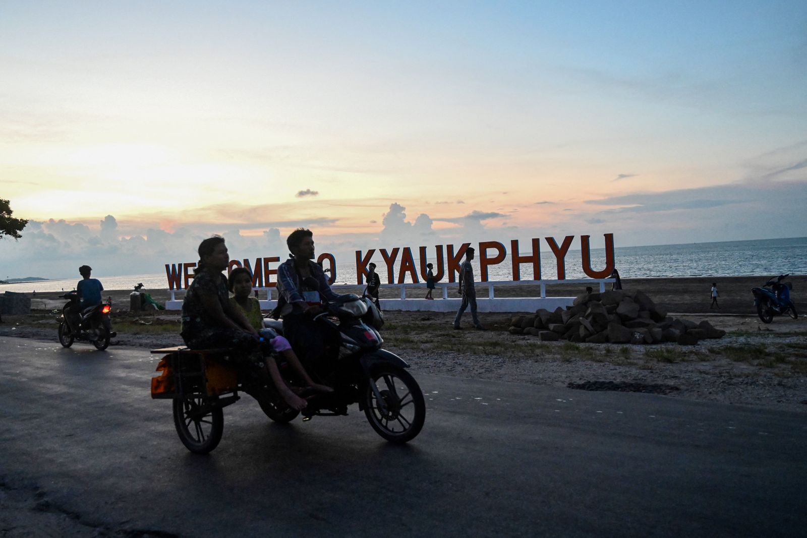 People travel along the beach of Rakhine State’s Kyaukphyu town on September 30, 2019. (AFP)