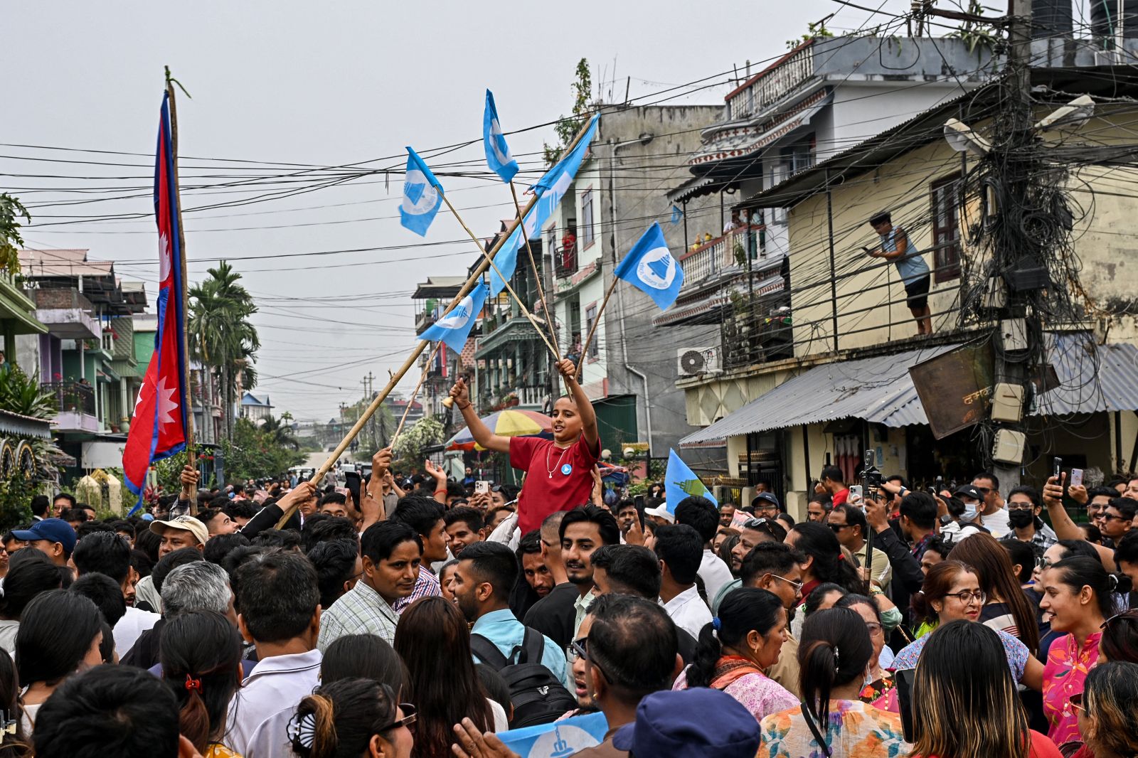 Supporters of the Rastriya Swatantra Party celebrate in the Nepali town of Damak on March 7, during the vote count for the country's parliamentary election. (AFP)