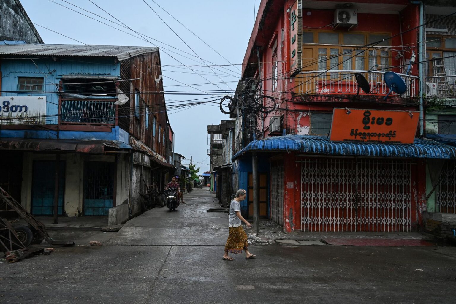 A woman walks past an empty market in the Rakhine State capital Sittwe on May 13, 2023. (AFP)
