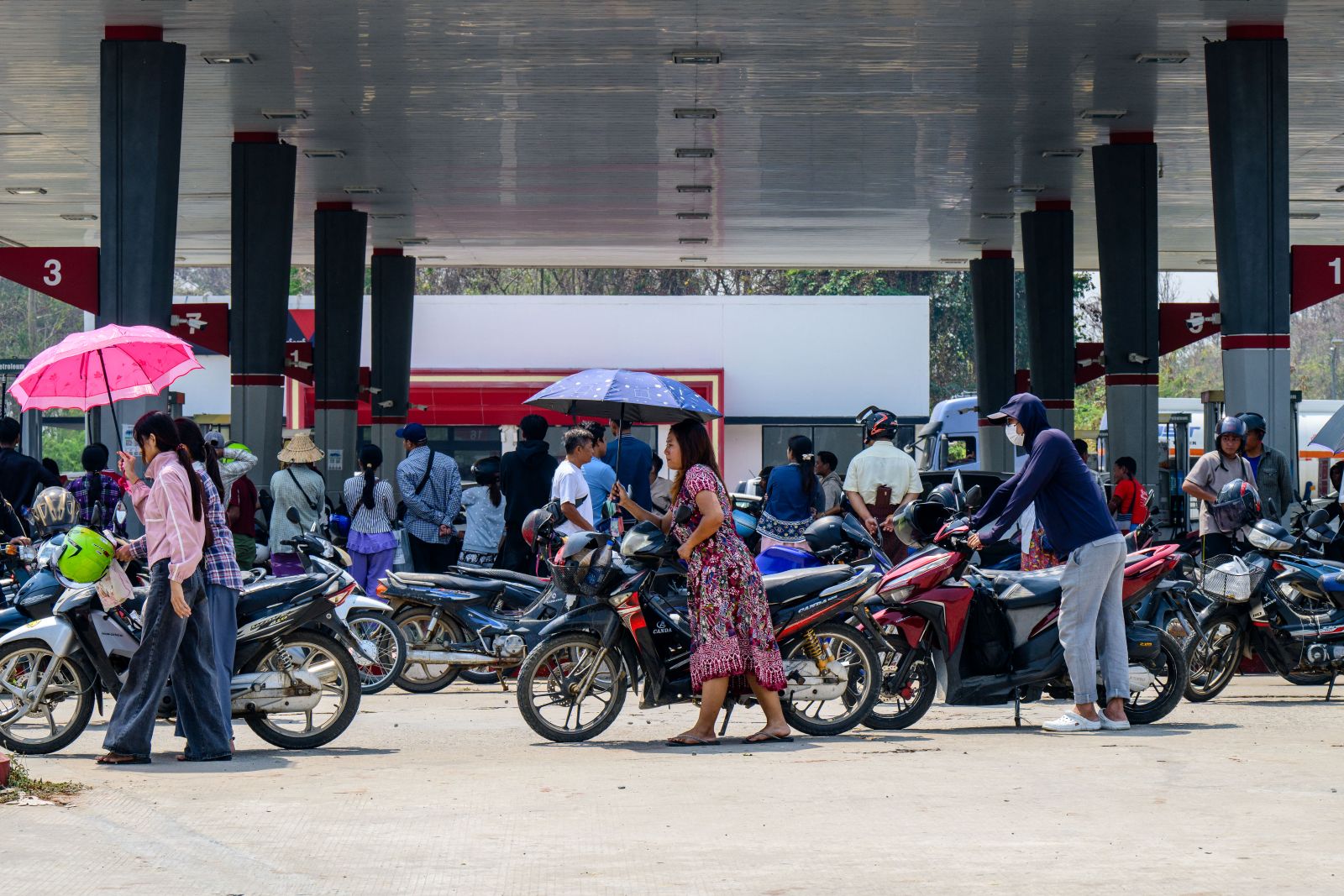 Motorists queue up to refuel their vehicles at a petrol station in Nay Pyi Taw on March 29. (AFP)