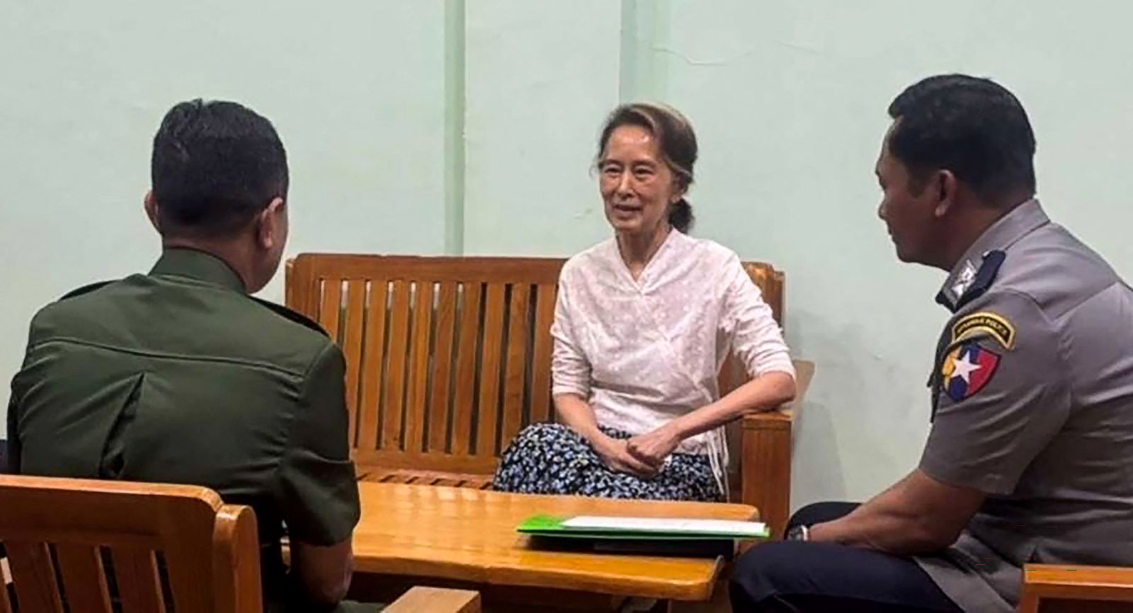 Undated picture from the Myanmar Military Information Team released on April 30 shows Aung San Suu Kyi talking with military officers in an undisclosed location. (AFP)
