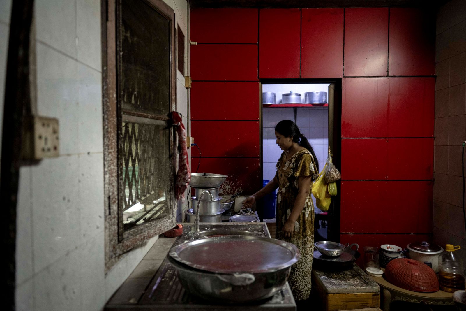 A woman cooks at a Rakhine traditional food restaurant in Yangon on May 13. (AFP)