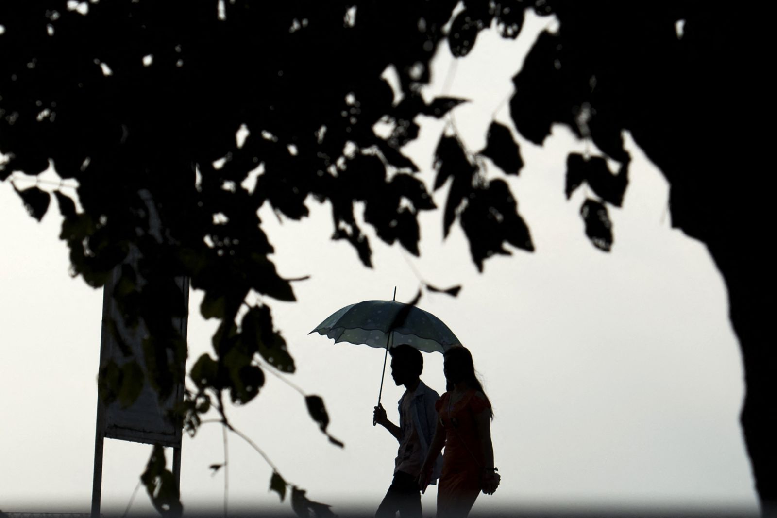 A couple walks in Inya Lake Park in Yangon on December 28, 2016. (AFP)