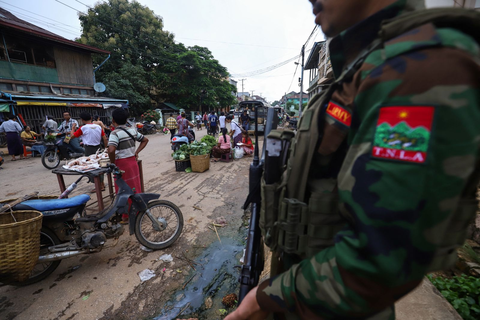 A member of the Ta'ang National Liberation Army keeps watch at a market in northern Shan State’s Kyaukme town on July 3, 2024. (AFP)