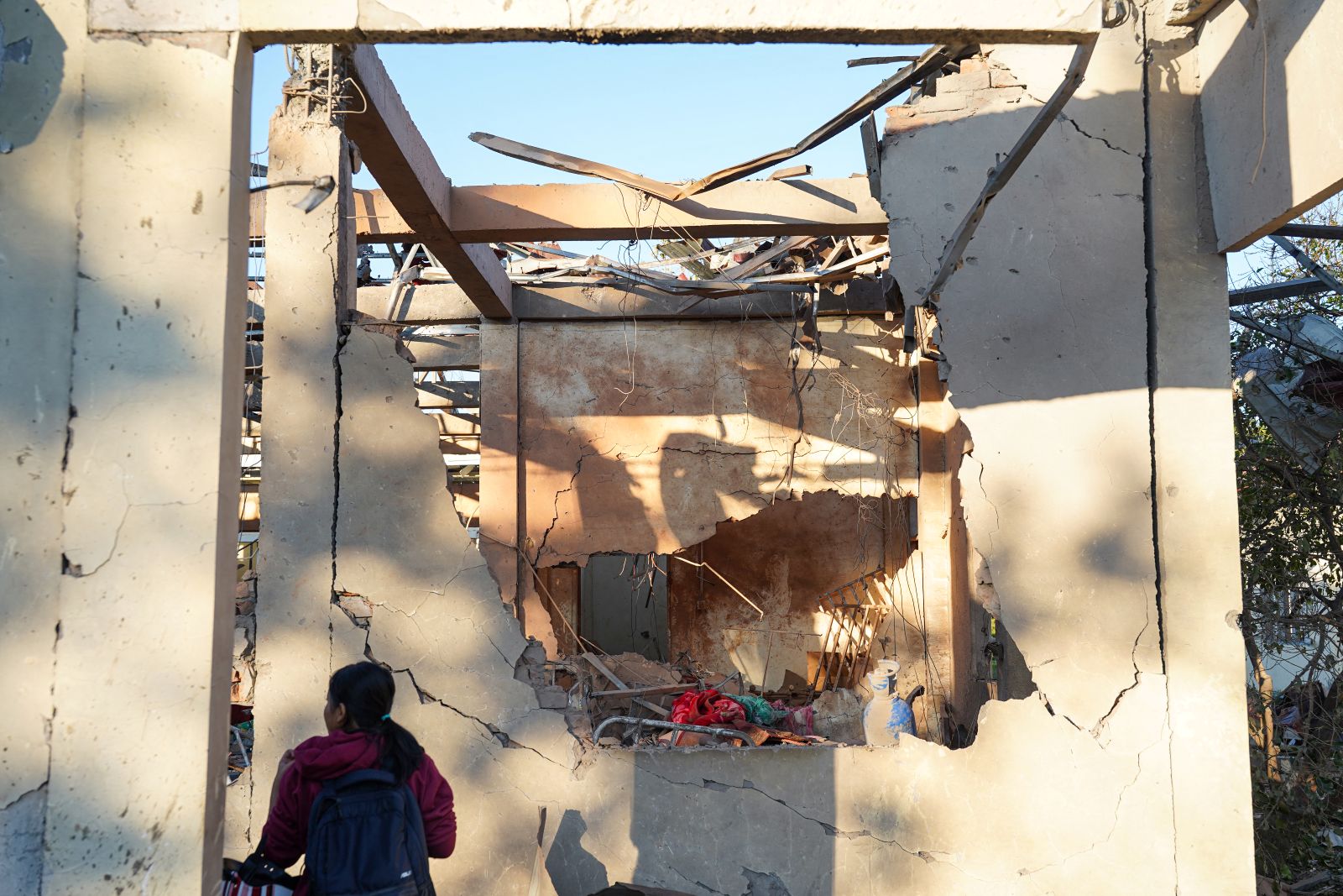 A woman inspects a hospital damaged by a regime military airstrike that killed more than 30 people in Rakhine State’s Mrauk-U town on December 11, 2025. (AFP)
