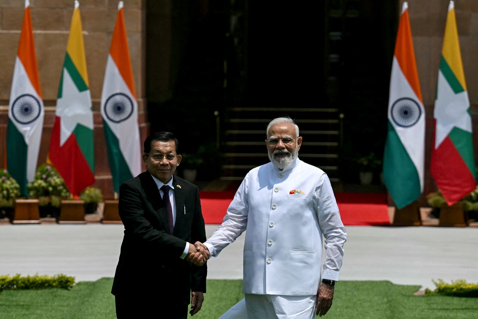 Regime president Min Aung Hlaing shakes hands with India’s Prime Minister Narendra Modi at the Hyderabad House in New Delhi on June 1. (AFP)