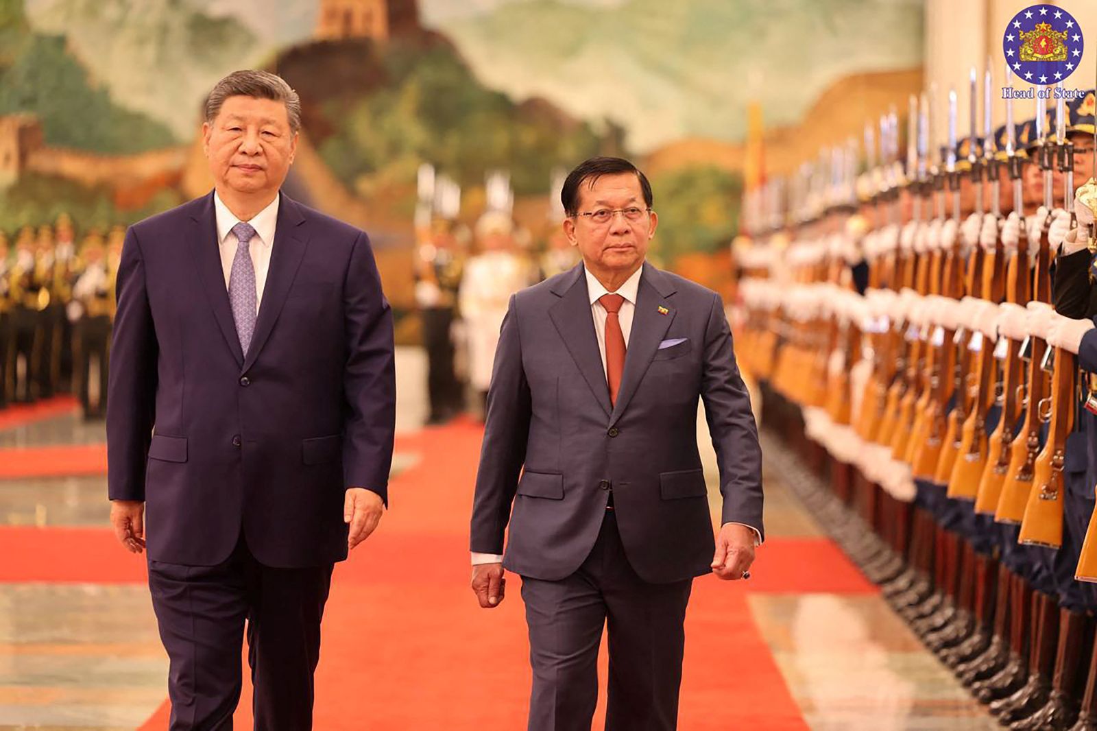 Myanmar regime’s president Min Aung Hlaing and China's President Xi Jinping inspect a guard of honour during a welcoming ceremony at the Great Hall of the People in Beijing on June 16. (AFP)