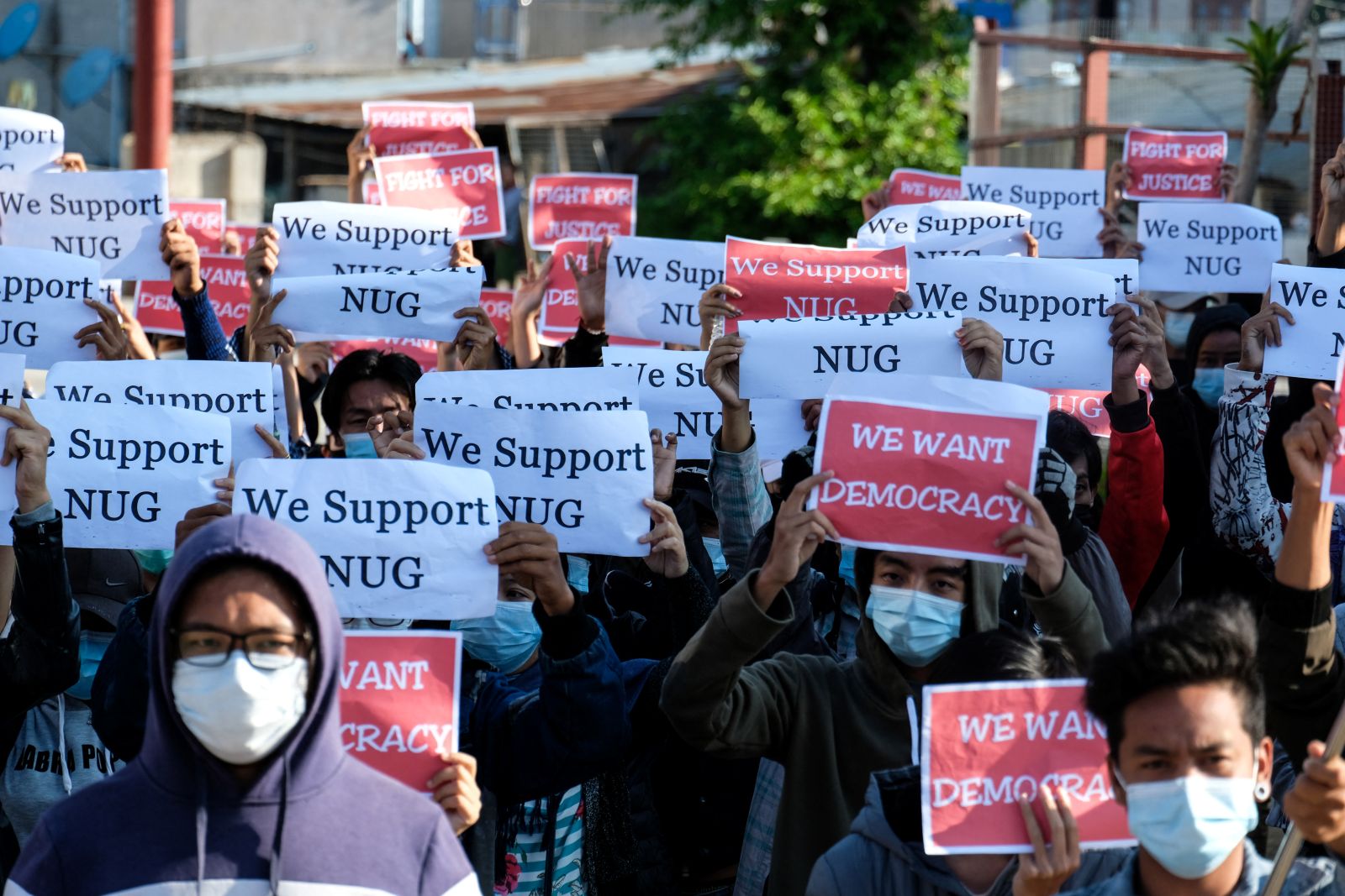 Protesters hold signs supporting the National Unity Government during a demonstration against the coup in the Shan State capital Taunggyi on May 2, 2021. (AFP)
