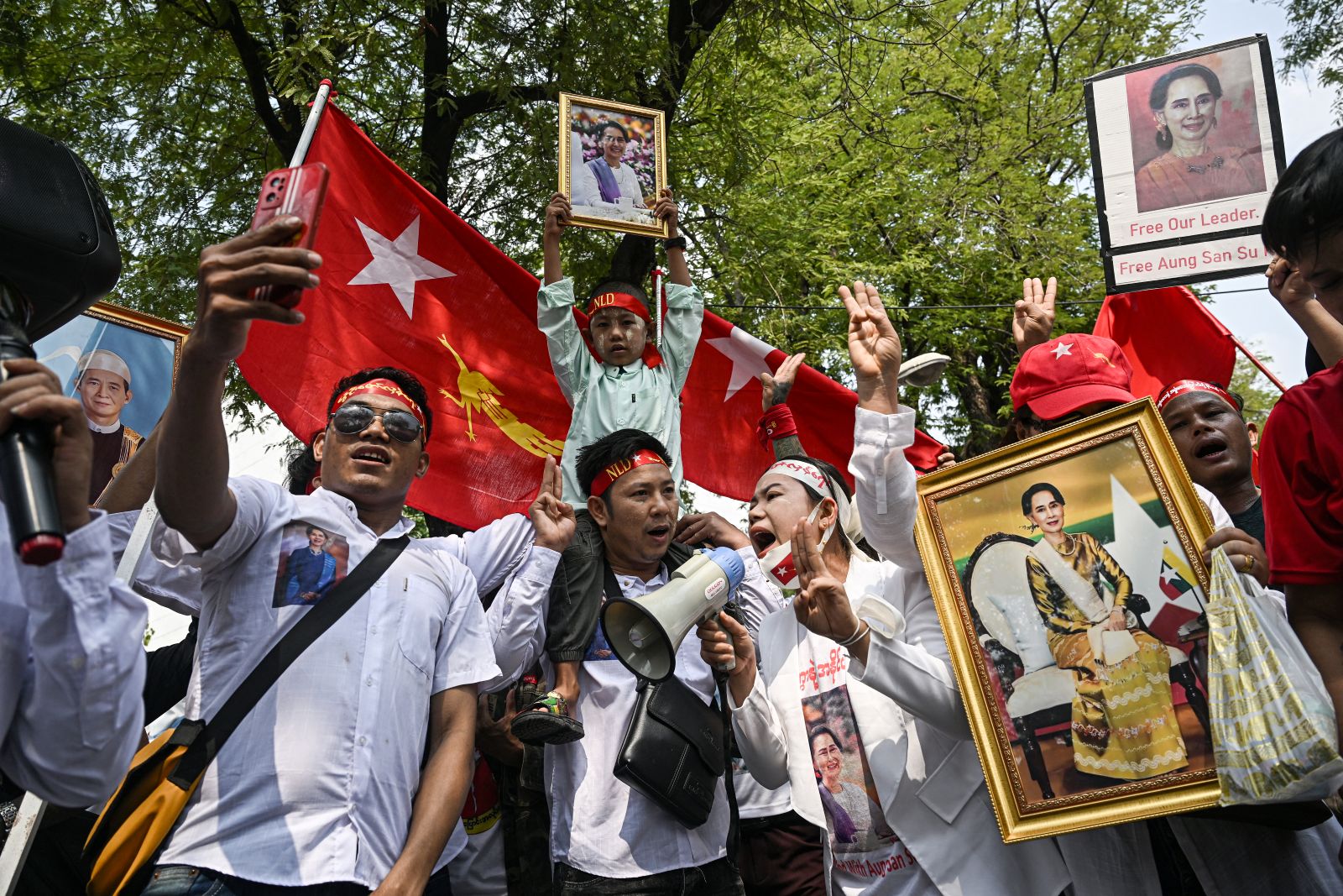 Protesters hold images of detained leader Aung San Suu Kyi outside the United Nations office in Bangkok on February 1, 2024. (AFP)