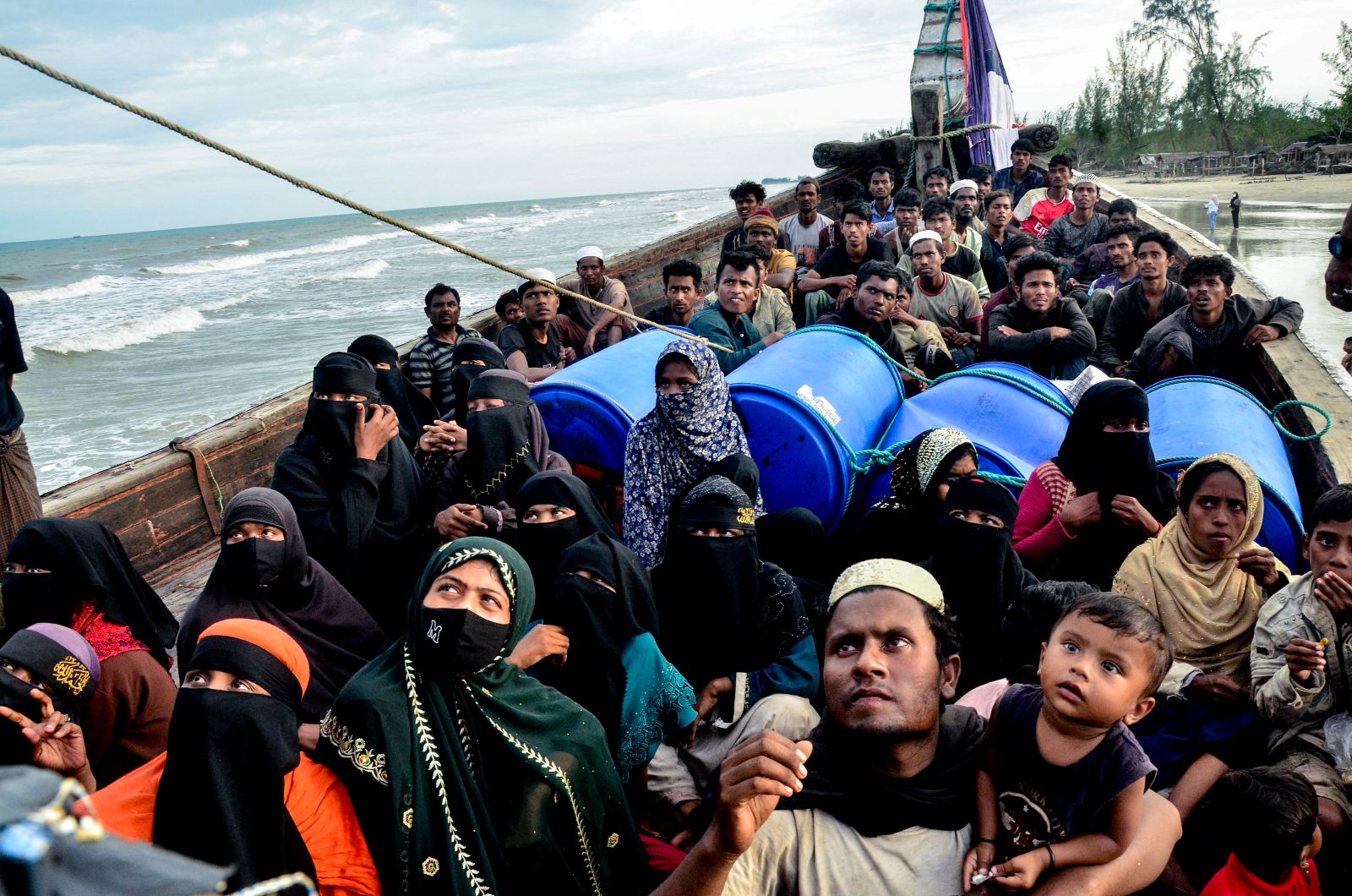 Rohingya refugees look on from their boat after authorities prevented them from disembarking and ordered them to remain on board in Indonesia's Aceh province on January 29, 2025. (AFP)