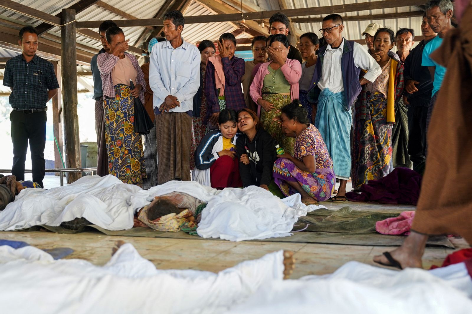 Mourners grieve during a funeral of victims of a regime airstrike on a hospital that killed more than 30 people in Rakhine State’s Mrauk-U town on December 11, 2025. (AFP)