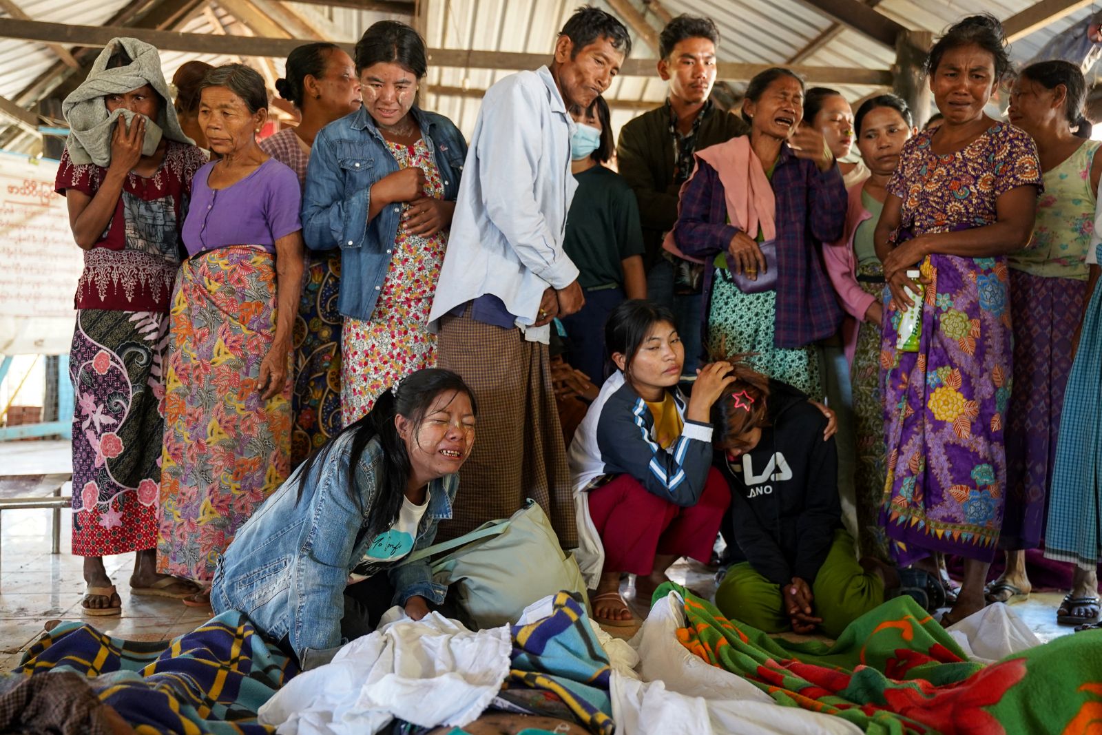 Mourners grieve during a funeral of victims of a regime airstrike at a hospital that killed more than 30 people in Rakhine State’s Mrauk-U town on December 11, 2025. (AFP)