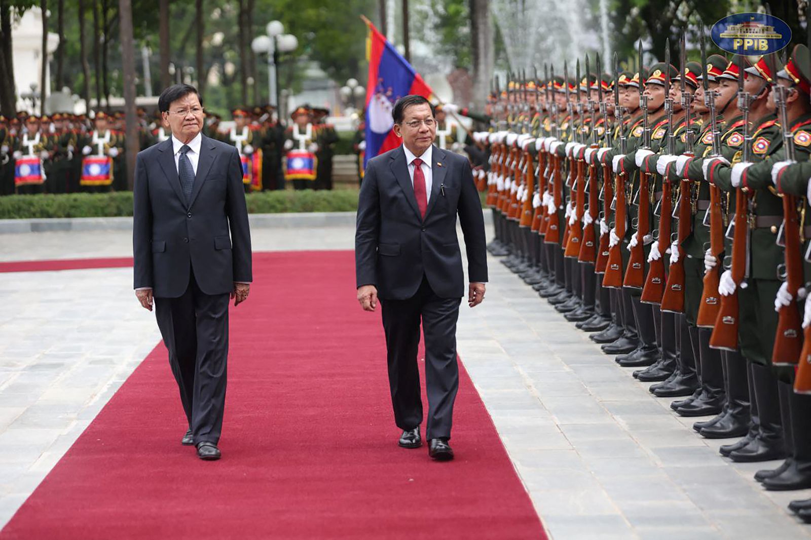 Myanmar regime's president Min Aung Hlaing and Lao President Thongloun Sisoulith inspect a guard of honour during a welcoming ceremony in Vientiane on July 3. (Myanmar's Presidential Press and Information Bureau | AFP)