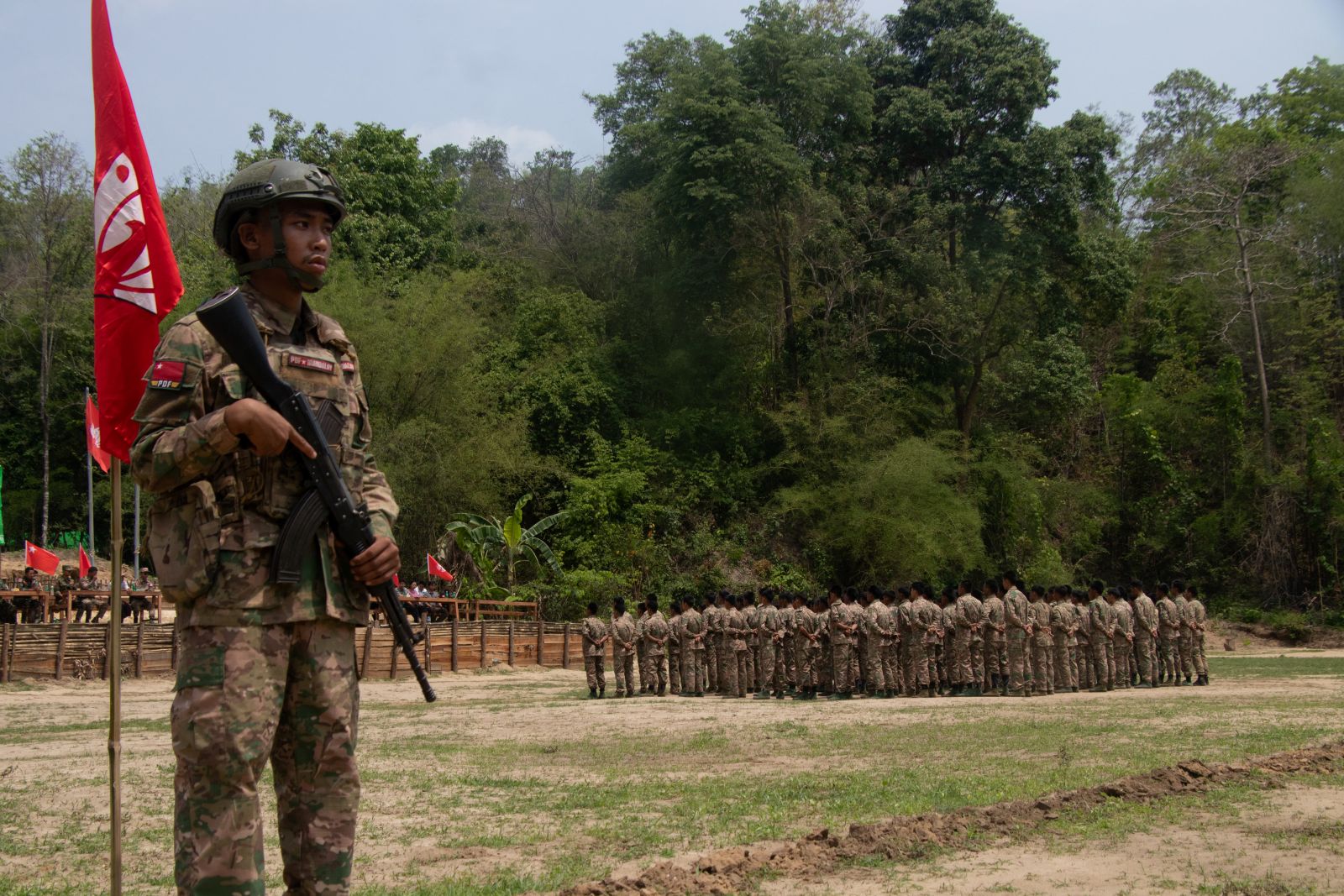 Members of the Mandalay People's Defence Force take part in a flag raising ceremony at a training camp in an undisclosed location in Sagaing Region on May 19. (AFP)