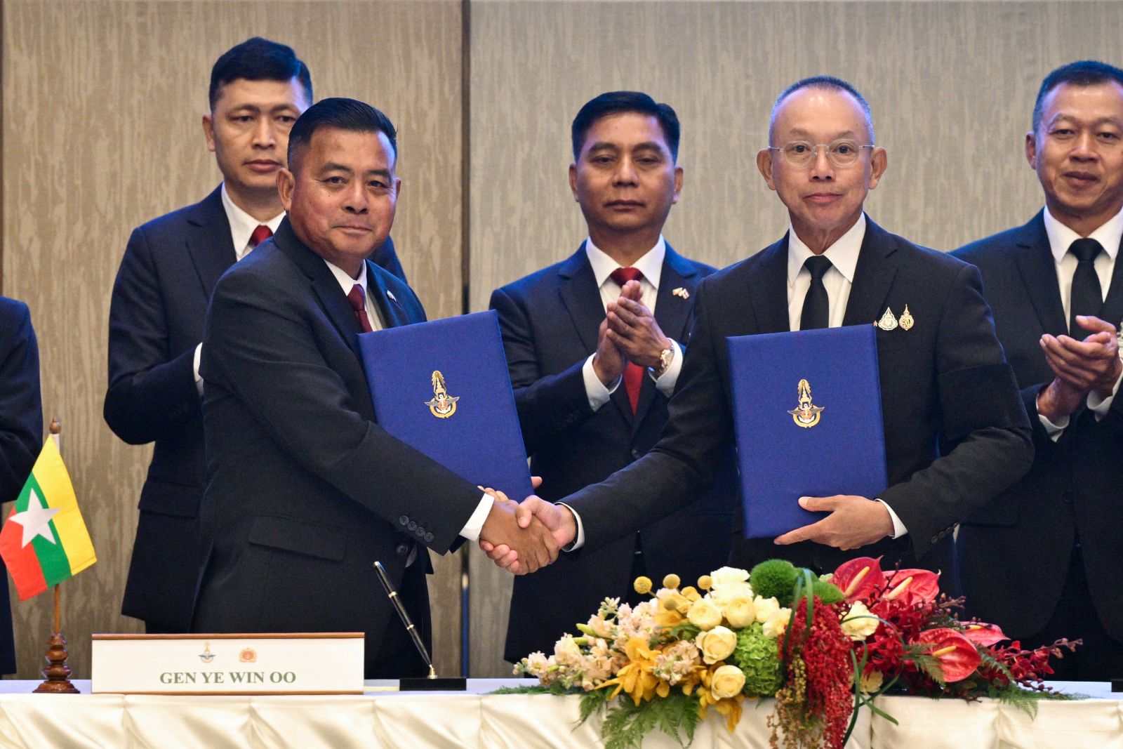 Myanmar’s military commander-in-chief General Ye Win Oo and Thailand’s Chief of Defence Forces Ukrit Boontanon shake hands after their High-Level Committee Meeting in Bangkok on August 20. (AFP)