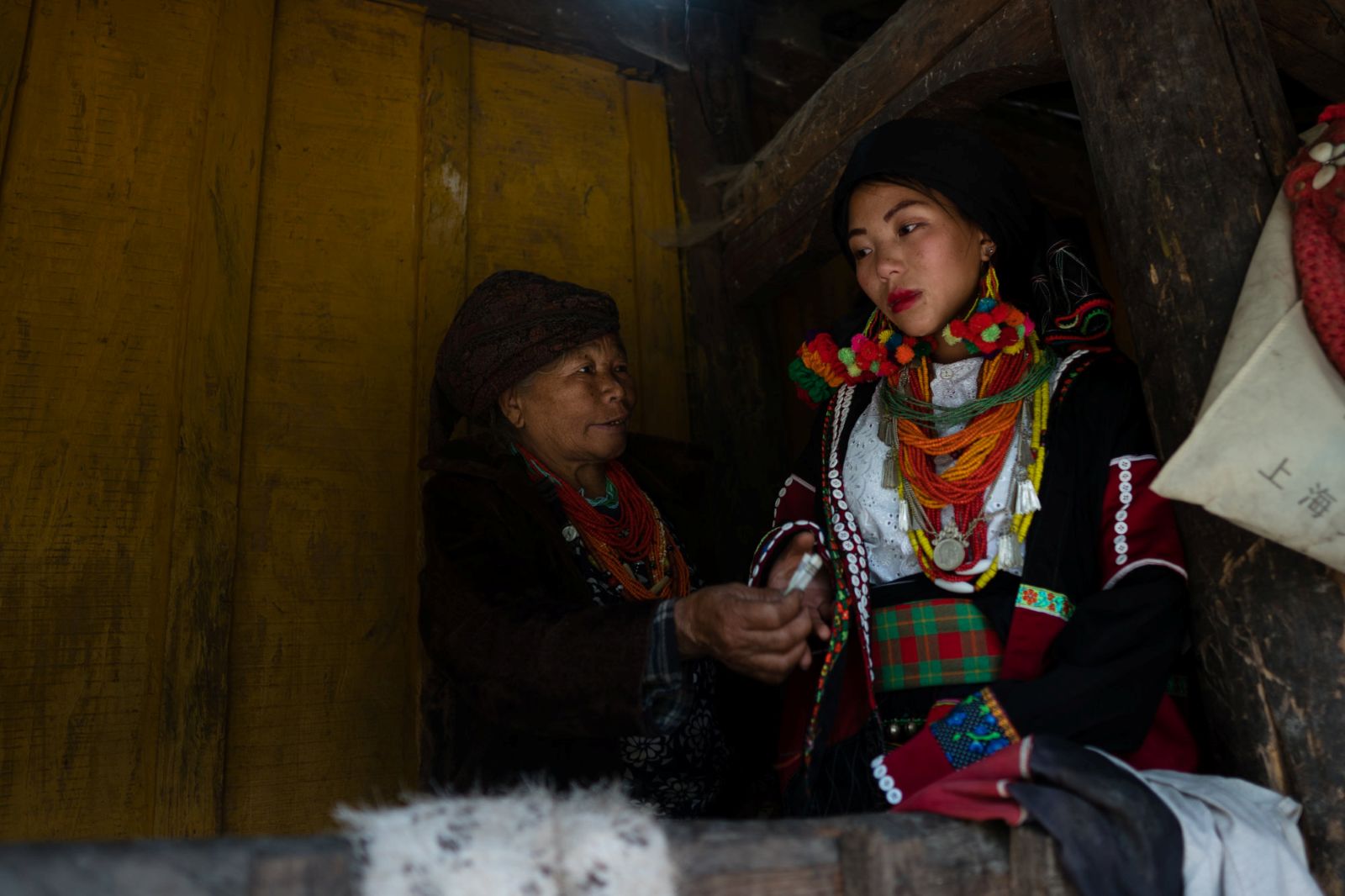 Kachin IDP Chan Myaw, 16, receives money from her grandmother on the day she was forced to marry a Chinese man in 2019. (Hkun Li | Frontier)