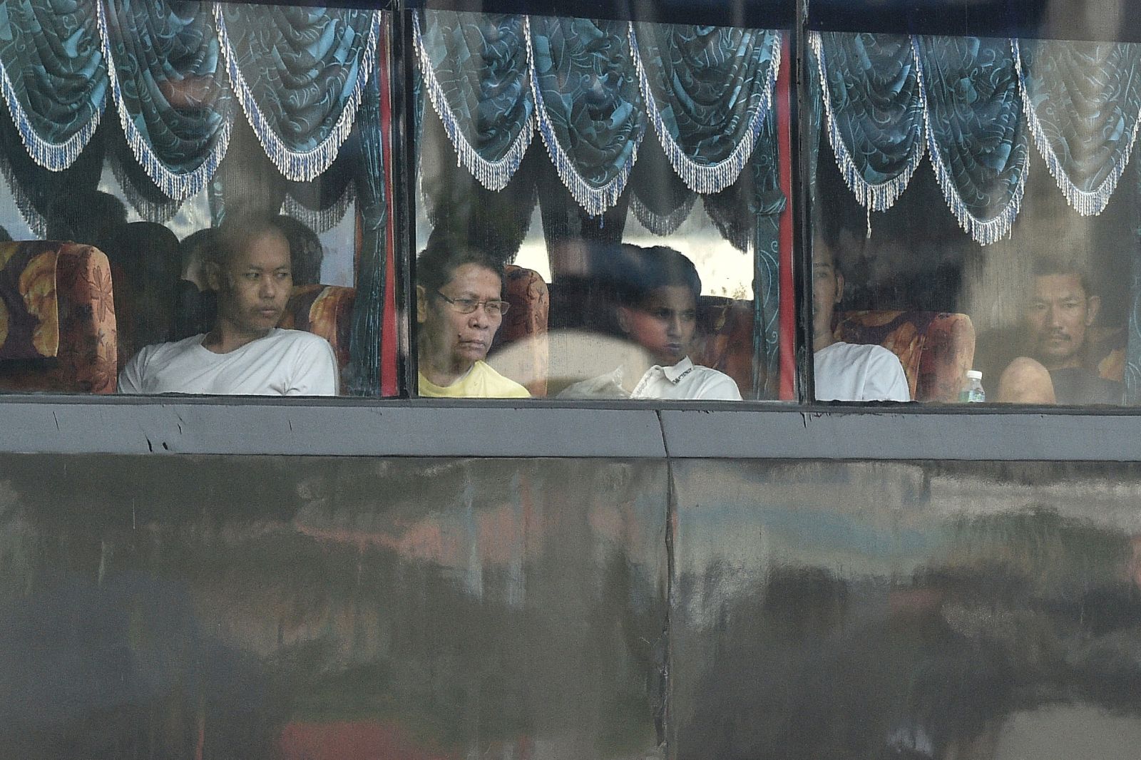 A bus carrying Myanmar nationals being repatriated from Malaysia heads toward a navel base in Lumut, on the outskirts of Kuala Lumpur, on September 29. (AFP)