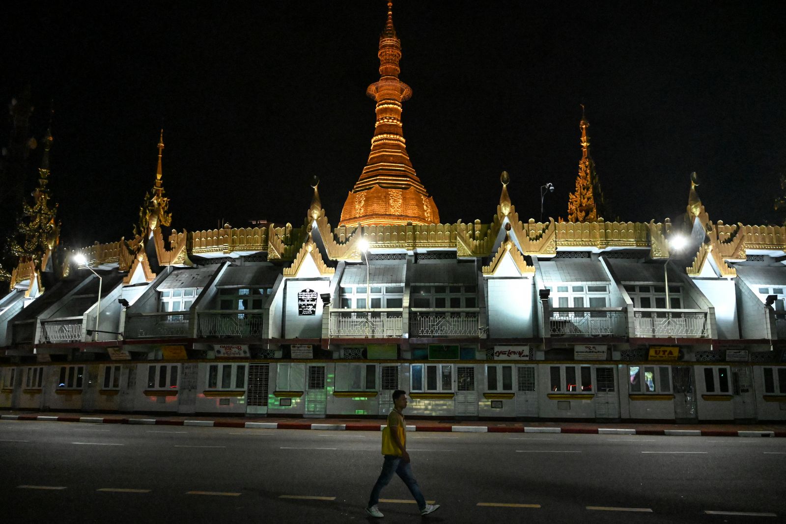 A man walks in front of the Sule Pagoda in Yangon on December 28, 2025. (AFP)